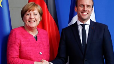 ماكرون وميركل يتفقان على تعزيز التعاون