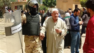 مجند يساعد مسن على الإدلاء بصوته في الاستفتاء  
